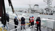 RFA Tidespring conducts her first ever RAS with a Royal Navy Warship HMS Sutherland in the background