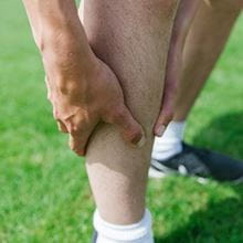 person holding their shin