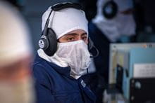 Navy warfare personnel with a mask and headphones on