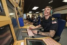two personnel at a computer