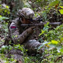 royal-navy-careers-royal-marines-02 Royal marine holds weapon whilst camouflaged by plants. Photograph taken at the new RM advert being filmed in Cyprus.