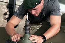 Marine commando completing work on equipment.