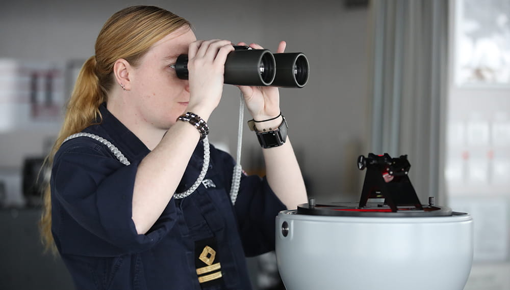 royal-navy-careers-RFA-cadetships-09 Navy personnel working whilst using binoculars.