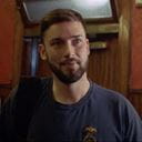 A still of a Royal Navy submariner talking to the camera in the crew mess
