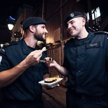 Royal Navy personnel trying food in Tokyo