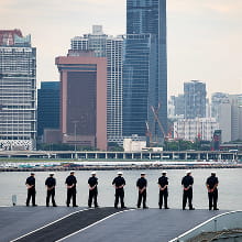 Royal Navy personnel on deck, as they come into dock