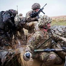 Royal-Navy-Equipment-Commando-Weaponry-05-L109A1-Grenade Close up of a hand holding a grenade poised to throw