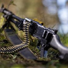 Royal-Navy-Equipment-Commando-Weaponry-06-General-Purpose-Machine-Gun A close up shot of a general purpose machine gun set down on the ground