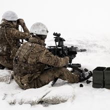 Royal-Navy-Equipment-Commando-Weaponry-07-Heavy-Machine-Gun Marine sat in the snow firing a heavy machine gun