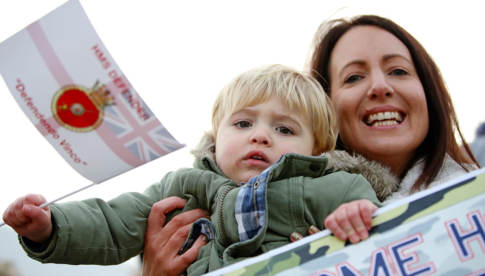 Royal-Navy-Families-05-Support Mother and son with flags and banners welcoming home