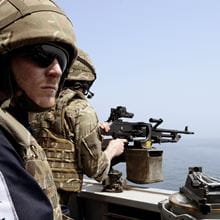 Royal Navy sailors man the guns onboard HMS Duncan