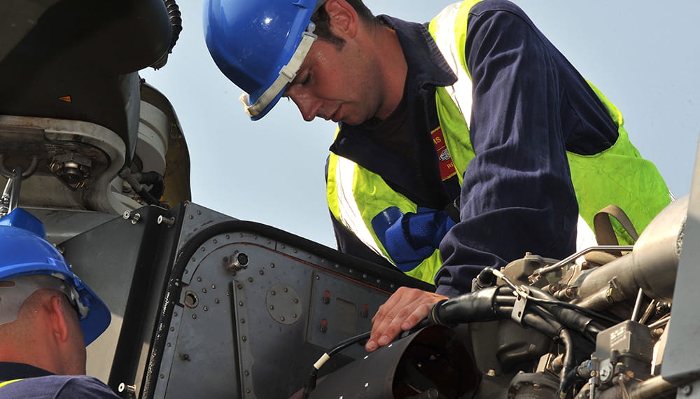 Royal-Navy-What-we-do-protect-05-supporting-employment.jpg Two Royal Navy engineers work on machinery