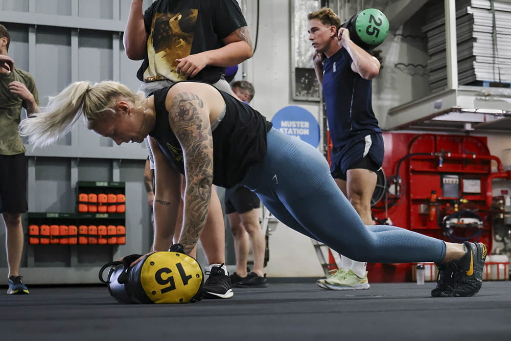 HMS Queen Elizabeth's ship's company take part in circuits in the hangar.