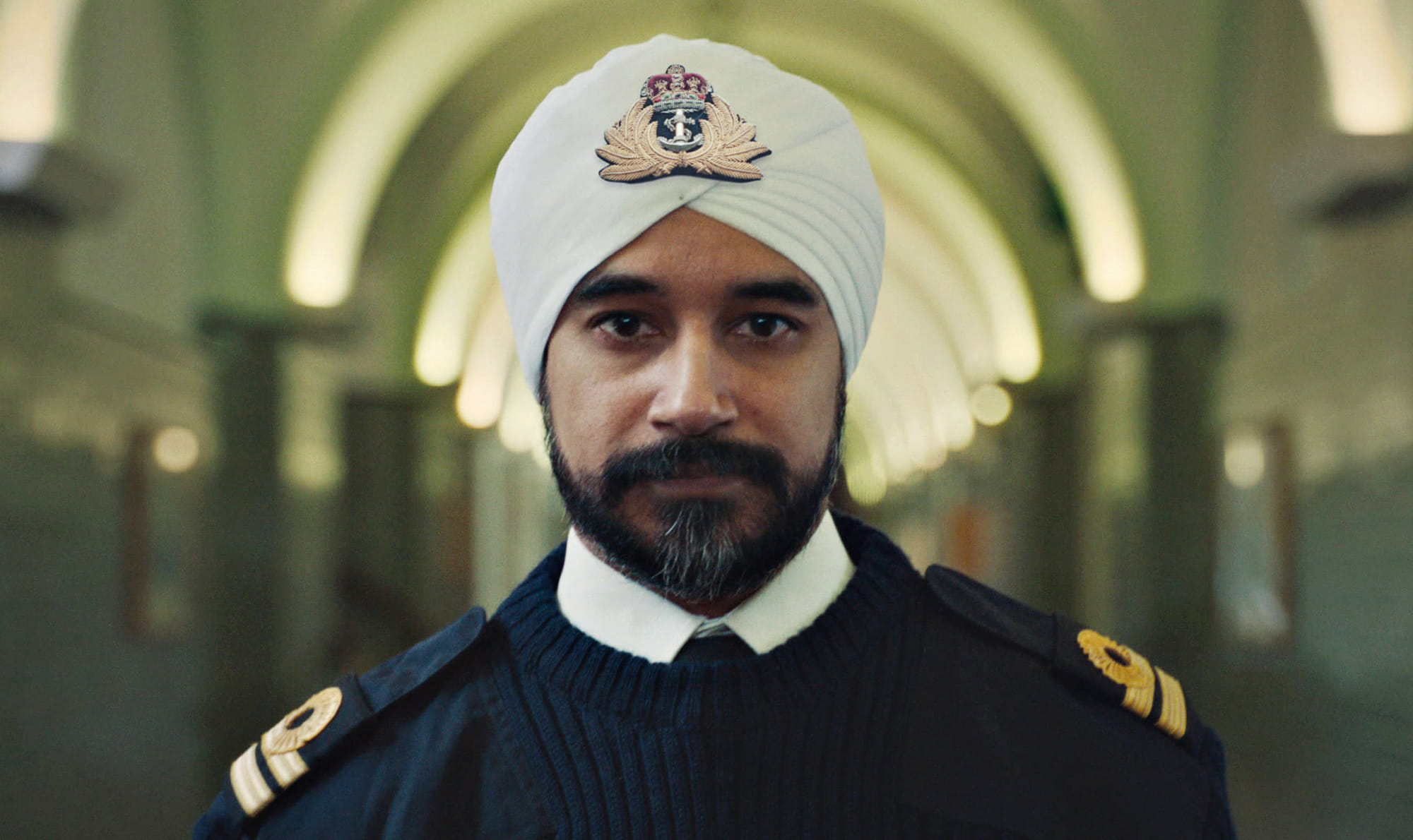 Royal Navy officer looks directly at the camera
