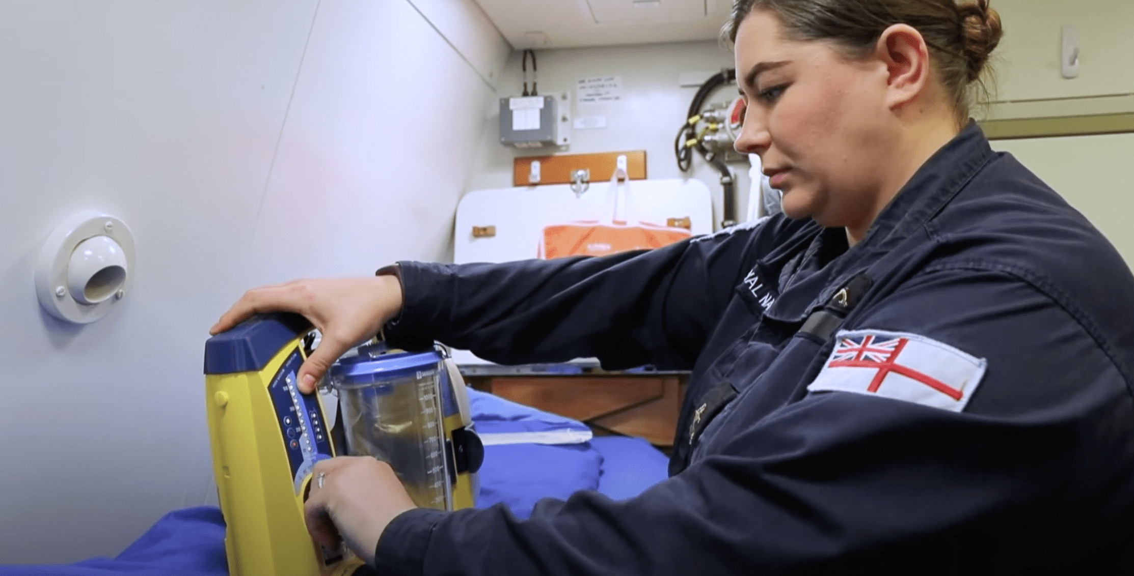 A medical assistant submariner onboard a submarine checking medical euipment 