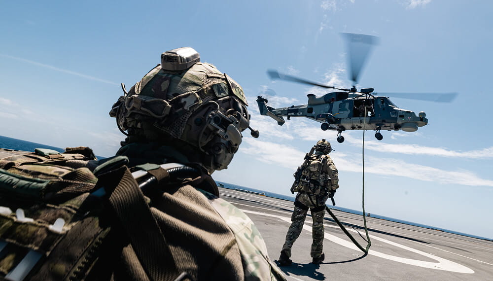 Royal Marines bringing in a helicopter to land