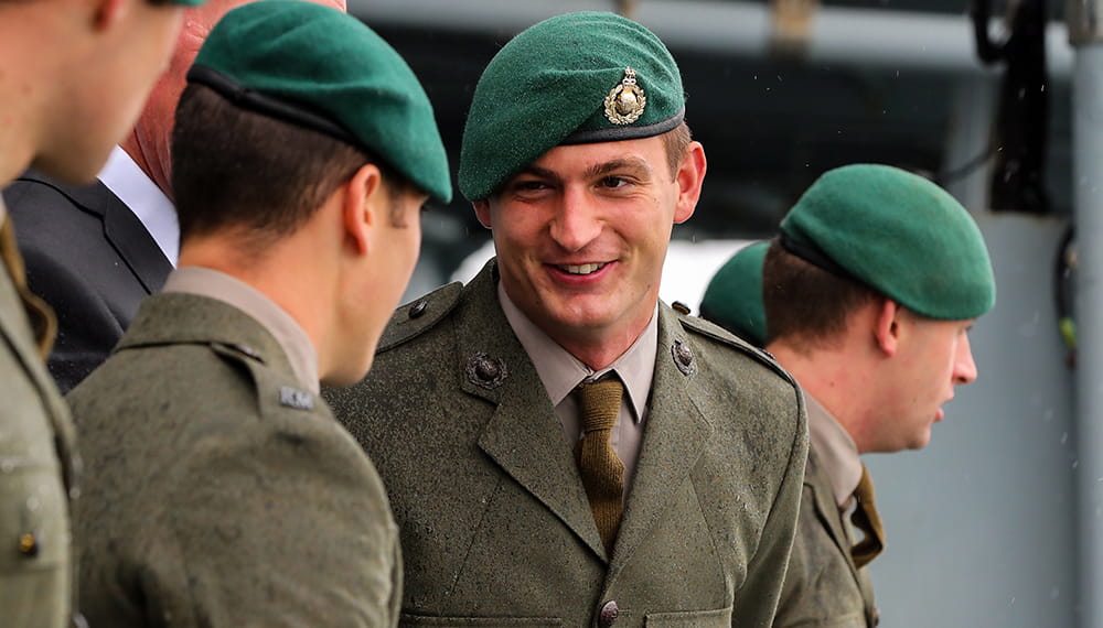 Royal marines talking and smiling whilst wearing their green berets. Feet flagship returns from successful Baltic deployment. The Fleet Flagship HMS ALBION has returned home to Devonport Naval Base after successful deployment.