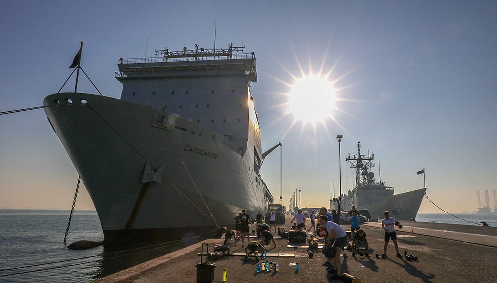 RFA Cardigan bay alongside Manama, Bahrain, with the crew of HMS MONTROSE doing circuits on the jetty.