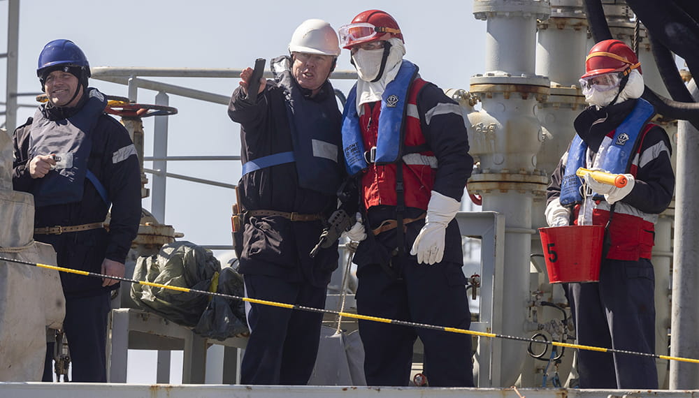 royal-navy-careers-royal-fleet-auxiliary-04 RFA Tidespring's personnel prepare to conduct a replenishment at sea. Personnel working, one points forward whilst the other listens another smiles.