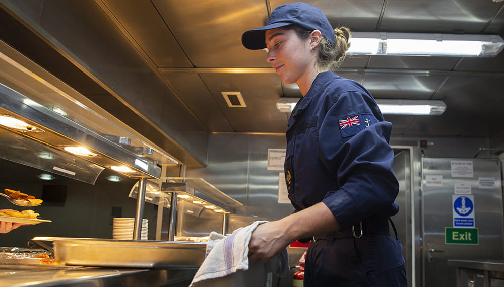 royal-navy-careers-RFA-apprenticeships-02 Steward carrying out their duties in the dinning hall of RFA Argus. RFA Argus personnel at work.