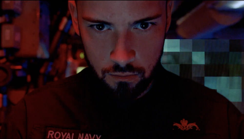 Submariner looking face onto the camera with a pixelated background
