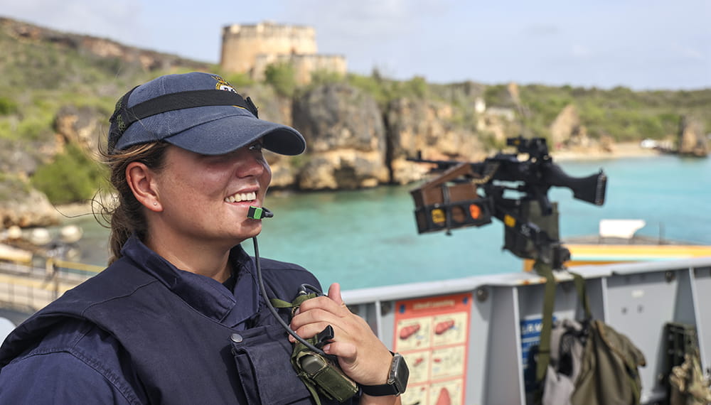 A Royal Navy Gunner smiles after safely over seeing the ships passage. HMS Medway arrives in Curacao for a stores replenishment.