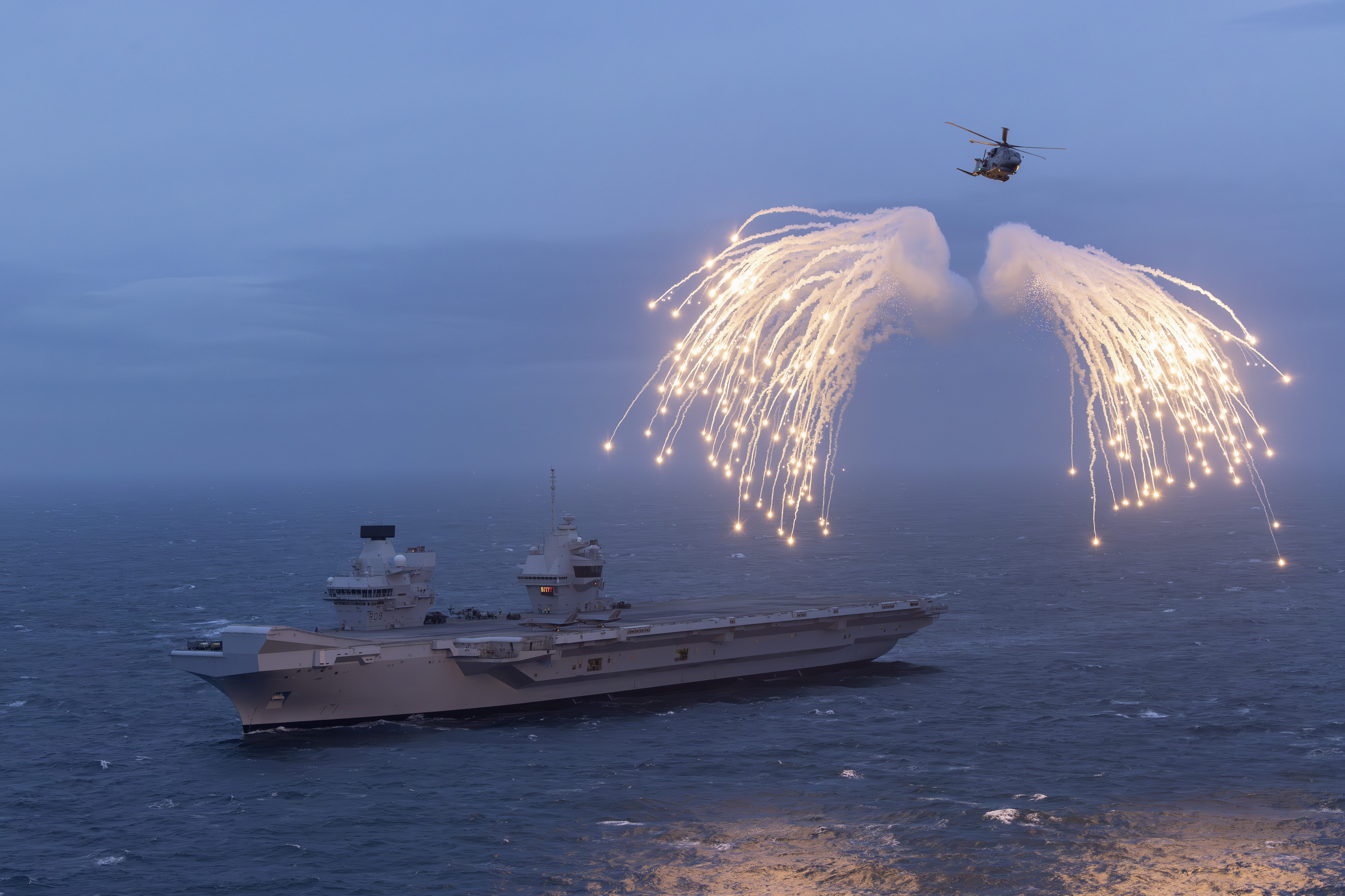 Prince of Wales carrier with a helicopter above 