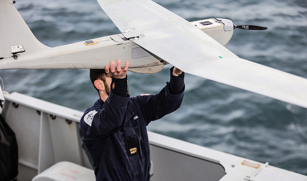 Surface Fleet personnel holding a Puma drone ready for launch