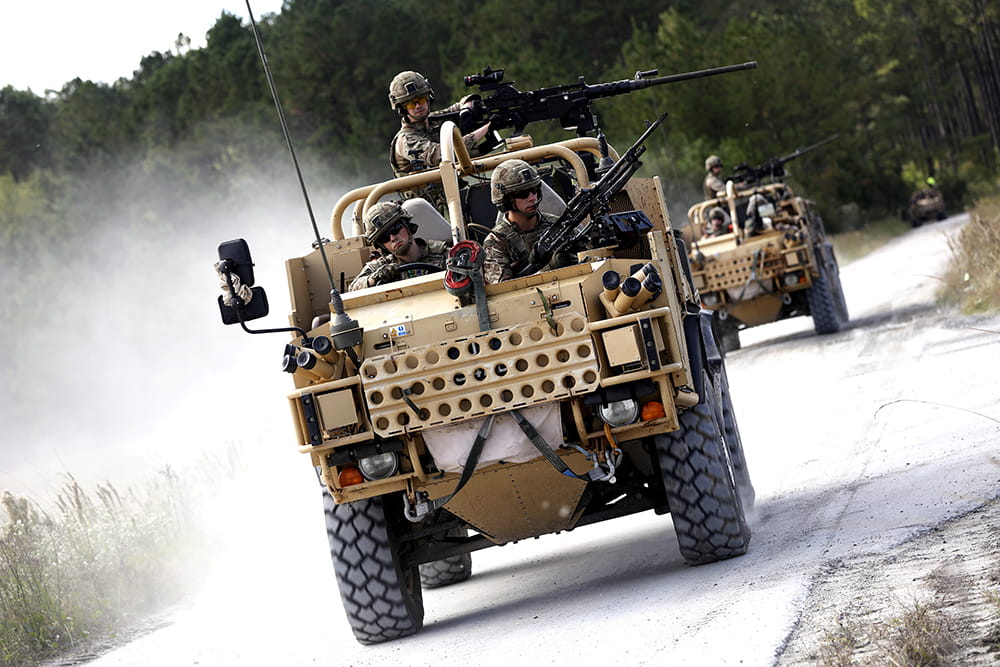 Royal-Navy-Equipment-Commando-By-Land-05-Jackal-2 Two Jackals driving towards camera wit a full compliment manning the guns