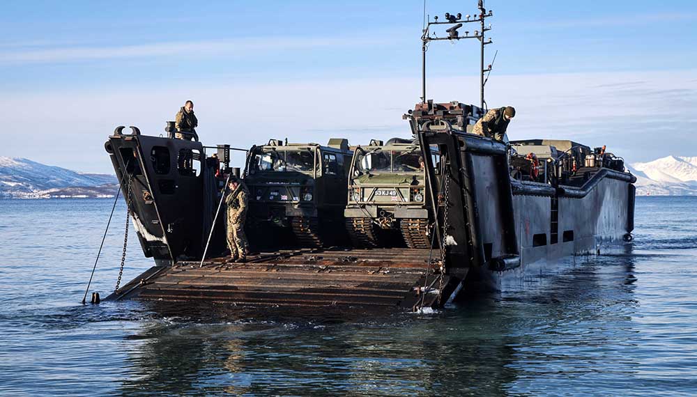 Marines unloading vehicles from an LCU