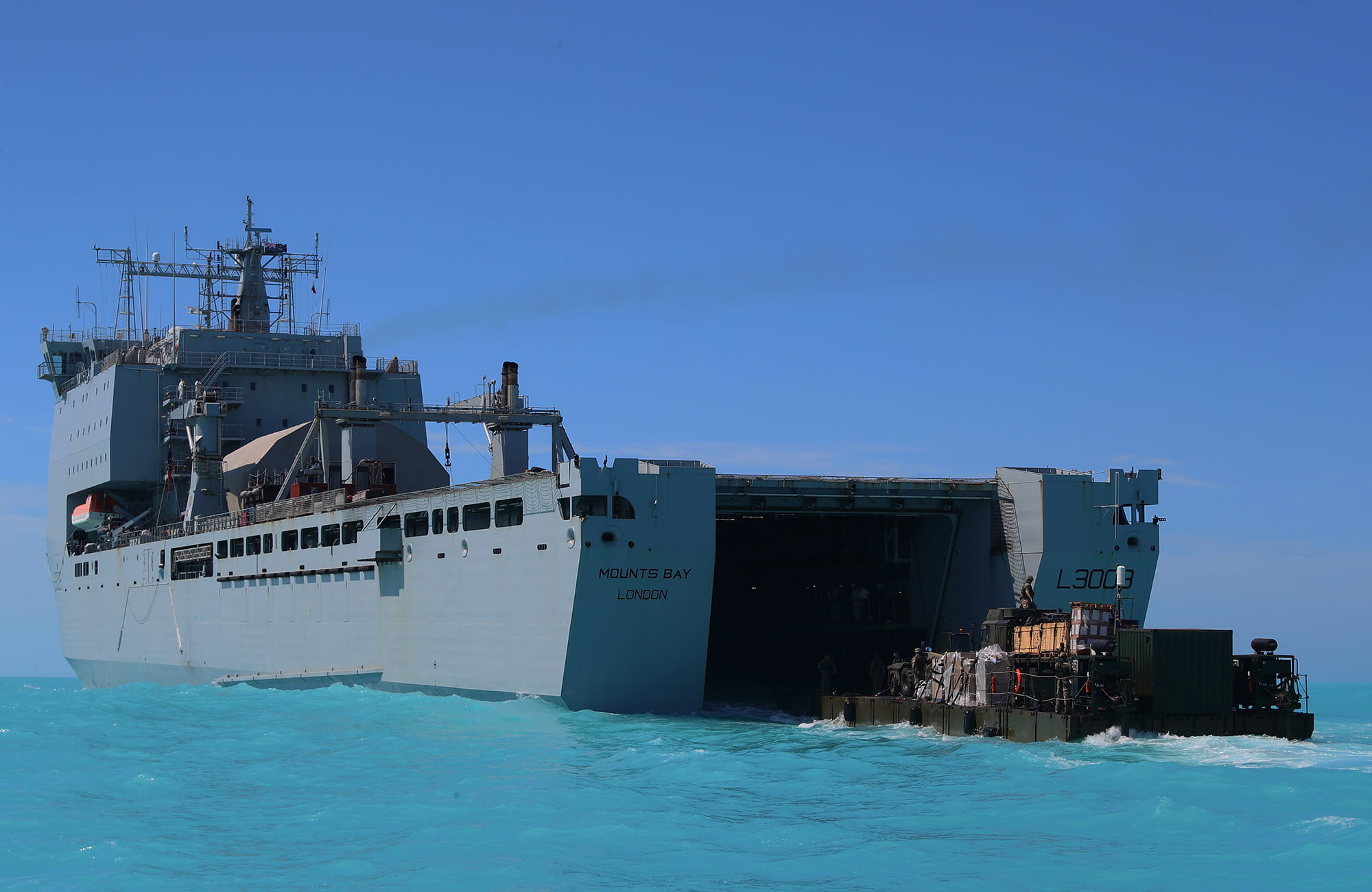 Rigid-hulled inflatable boat being deployed from the hull of the RFA Mounts Bay