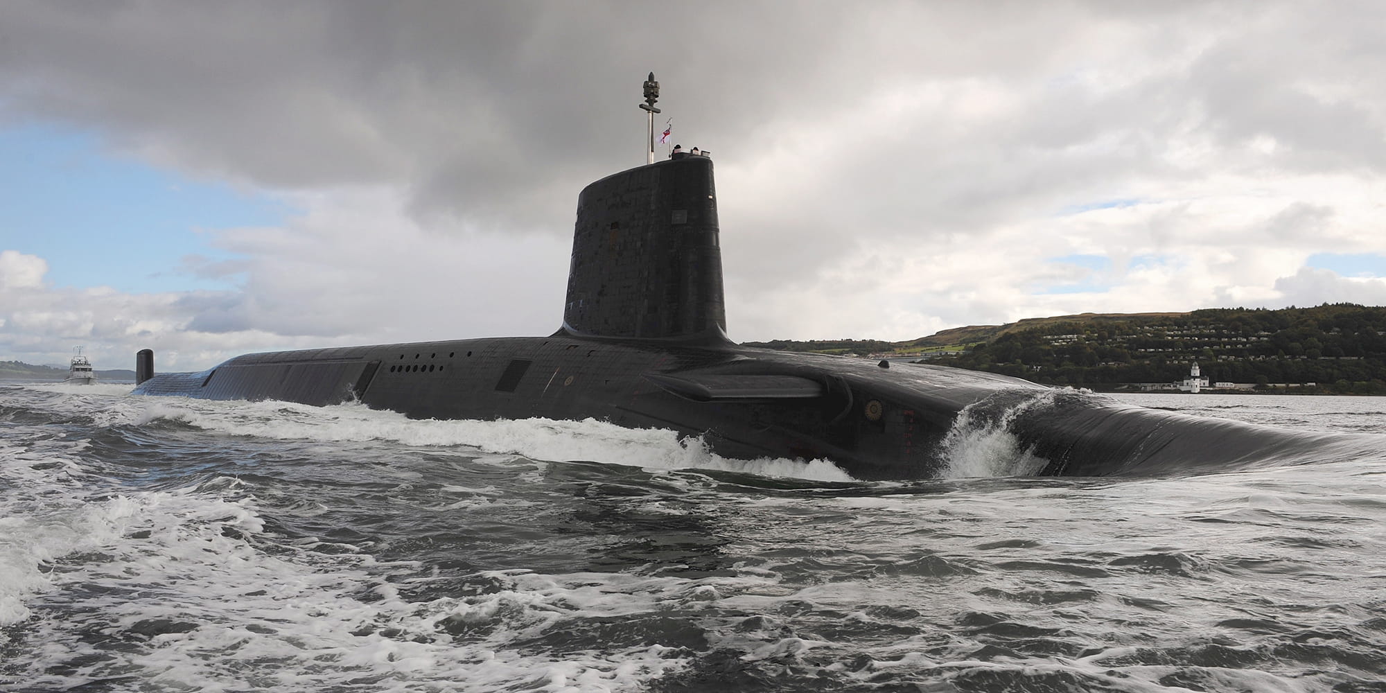 HMS Victorious leaving HMNB Clyde, top half of sub visible above the water