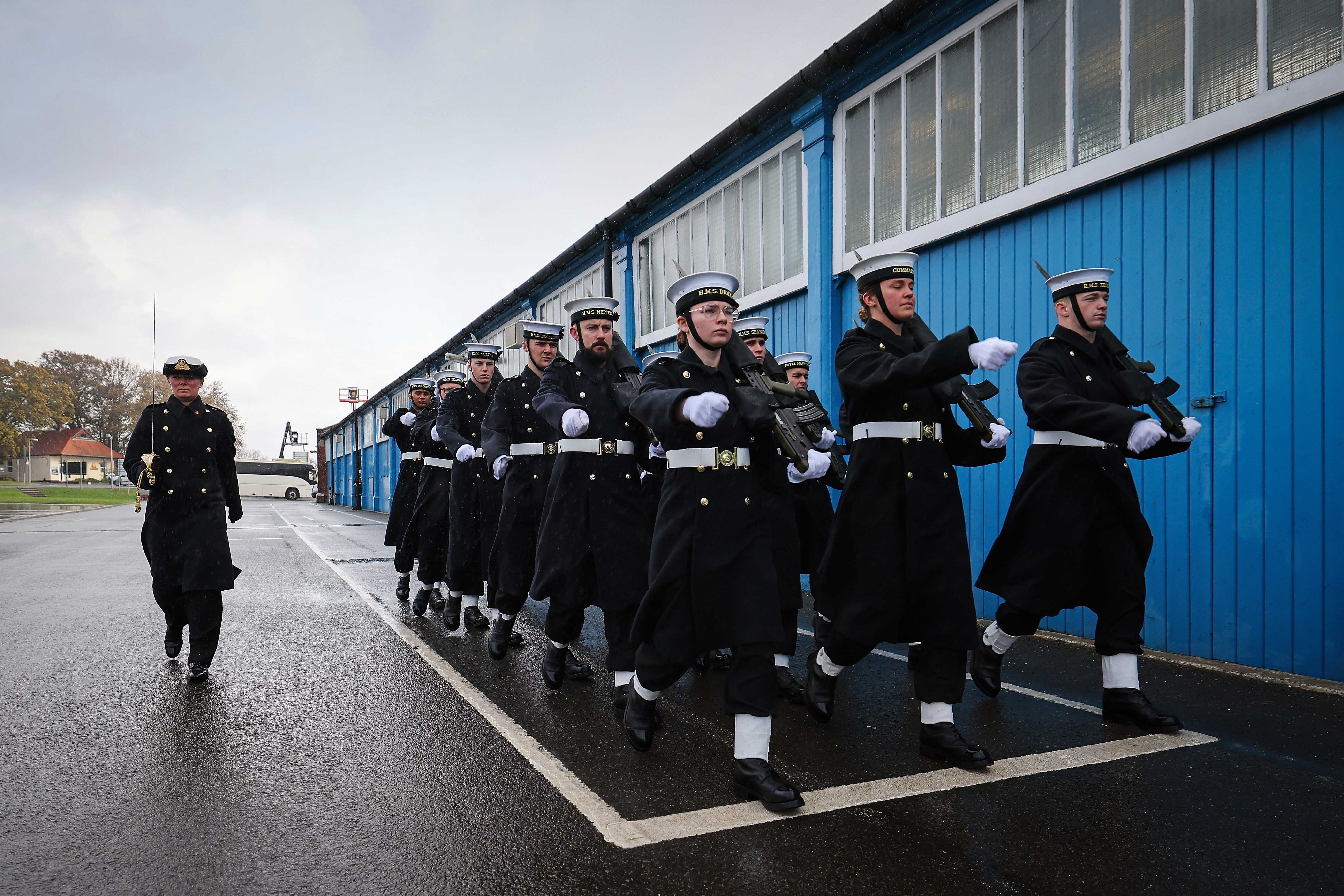 Royal-Navy-Locations-and-Operations-02-Bases-and-Stations Officers and Ratings marching outside blue building at HMS Excellent