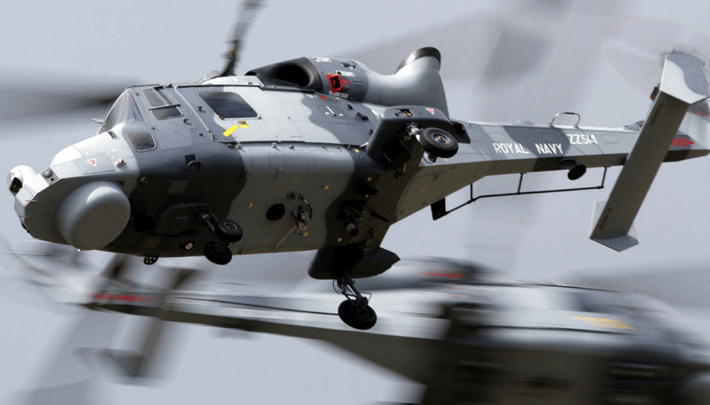 Two wildcat helicopters cross paths in the sky