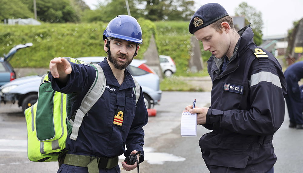 The Doctor gives a situation report as a casualty is moved to the field hospital