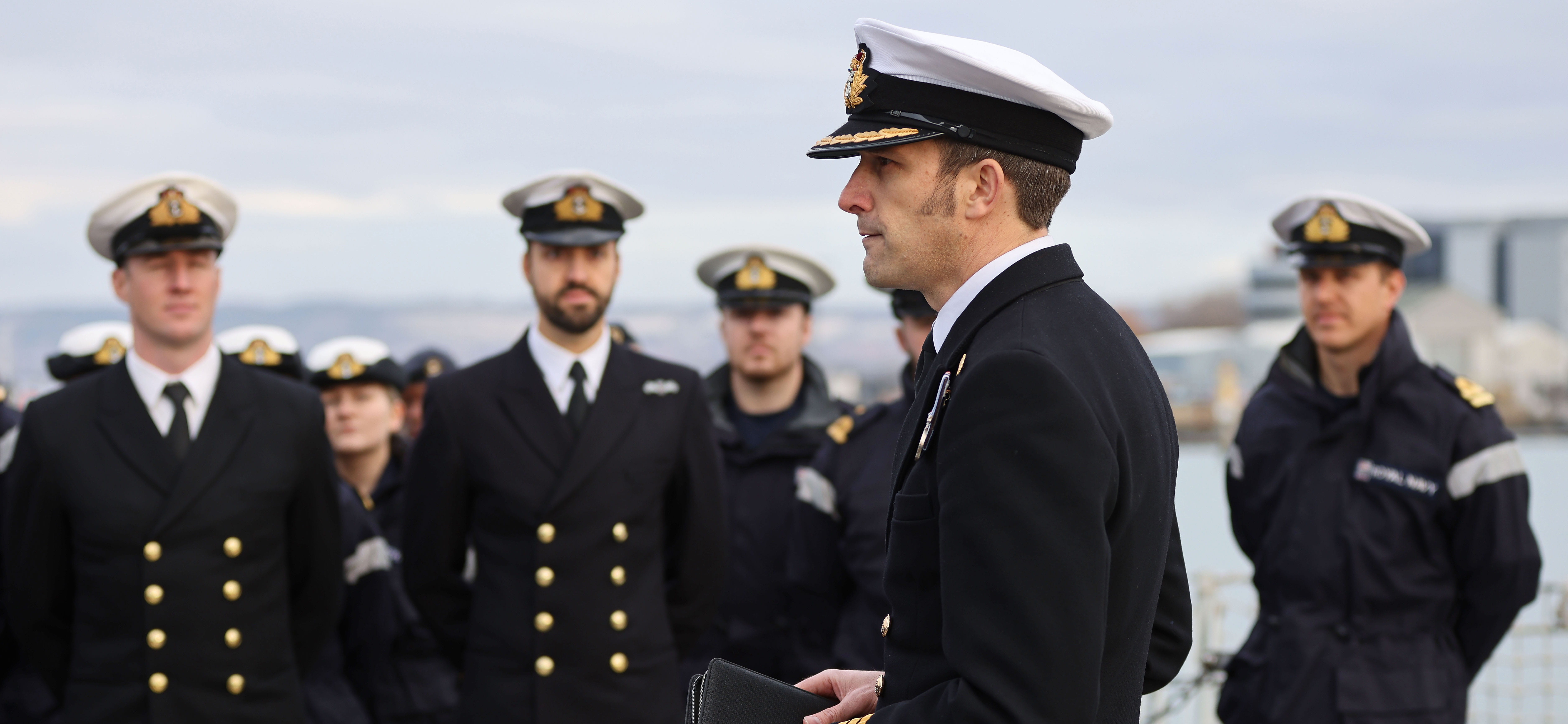 Commanding Officer of HMS Kent addresses the ships company on the flight deck.