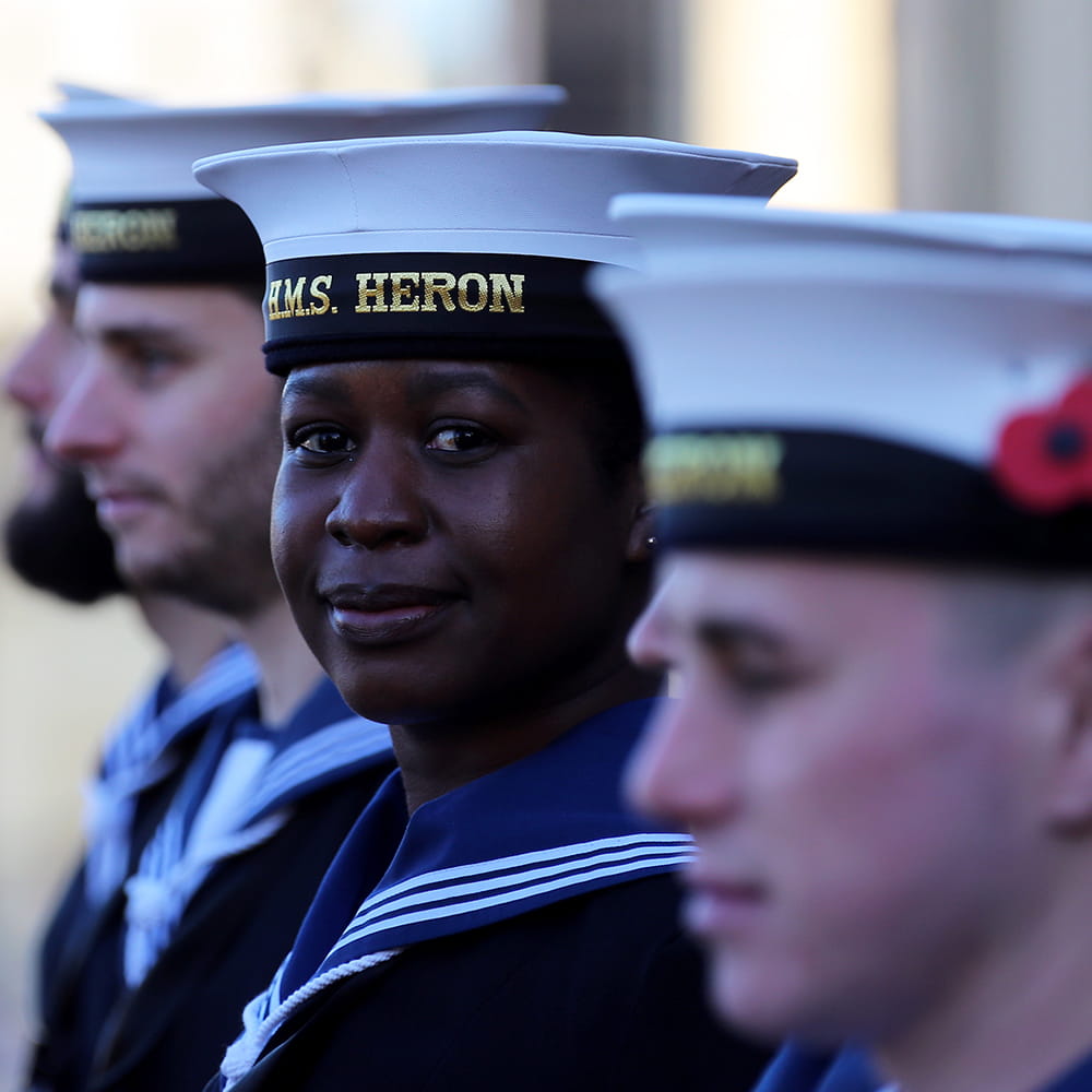 Royal-Navy-Our-People-03-unity.jpg Royal Navy sailors on parade, one lady smiles at the camera